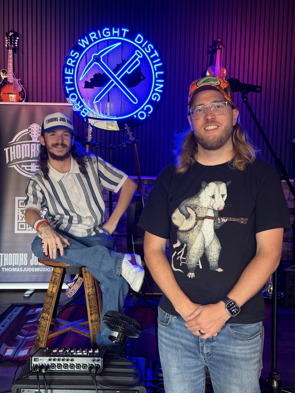 Thomas Jude and a bandmate posing at Brothers Wright Distilling Co.